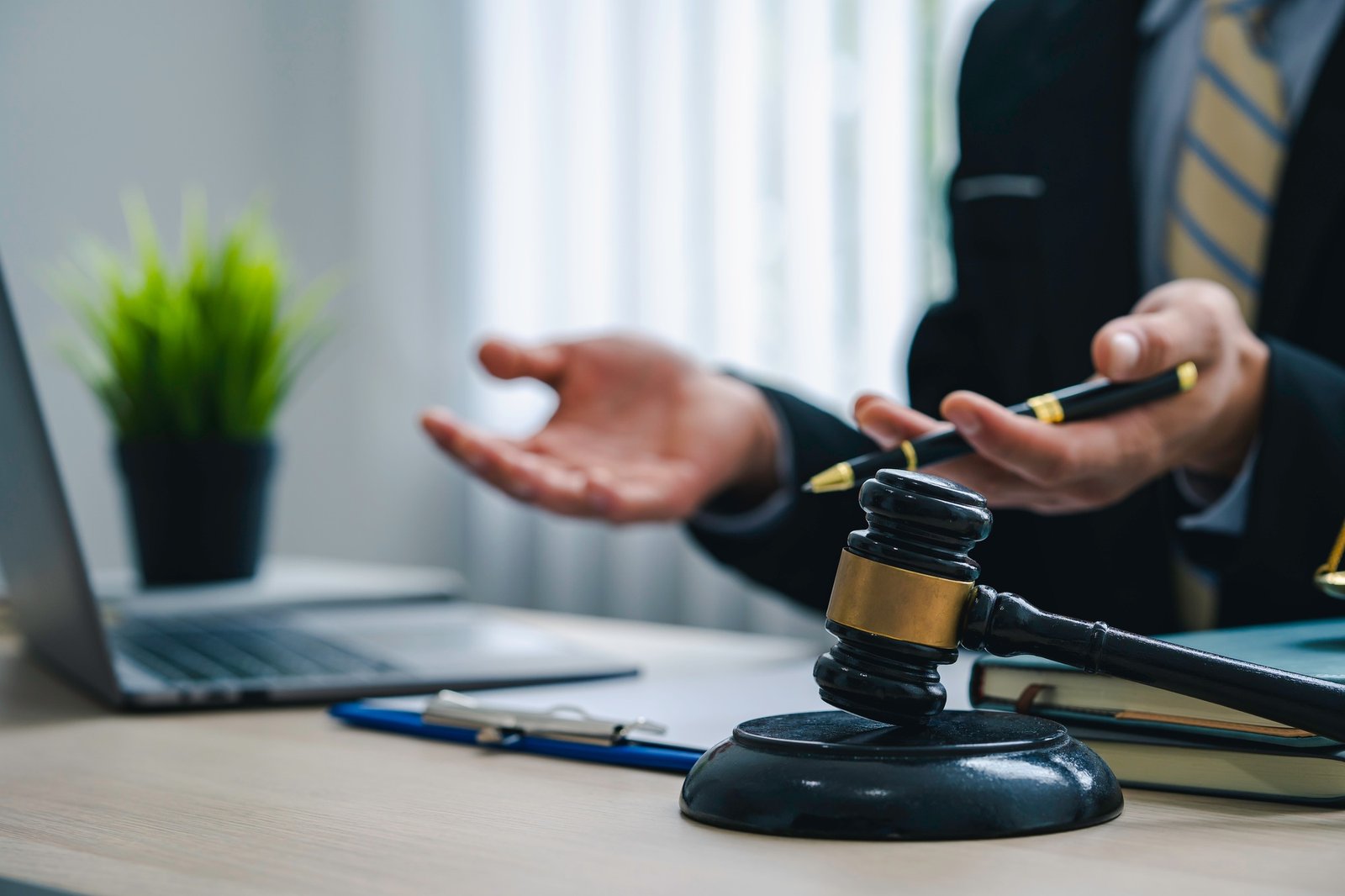 A lawyer or judge provides legal advice to clients in an attorney's office. legal advisor Scales of