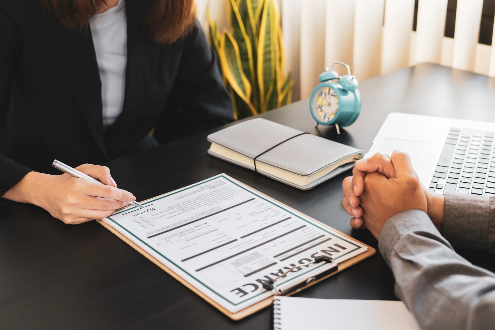 Male insurance agents are giving advice and signing a contract. In terms of insurance such as home,