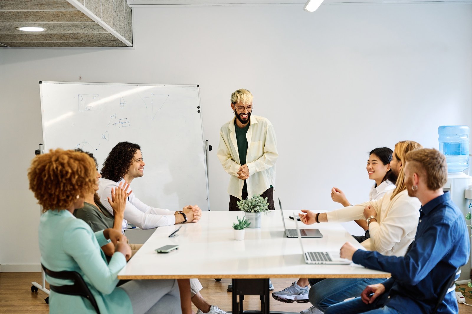 Young modern man leading an international meeting in a coworking